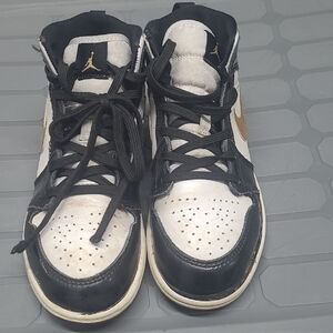 Nike Mid-Top Sneakers in Black, White, and Gold